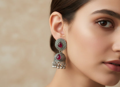 Traditional Oxidized Silver-Toned Jhumka Earrings with Red Stone