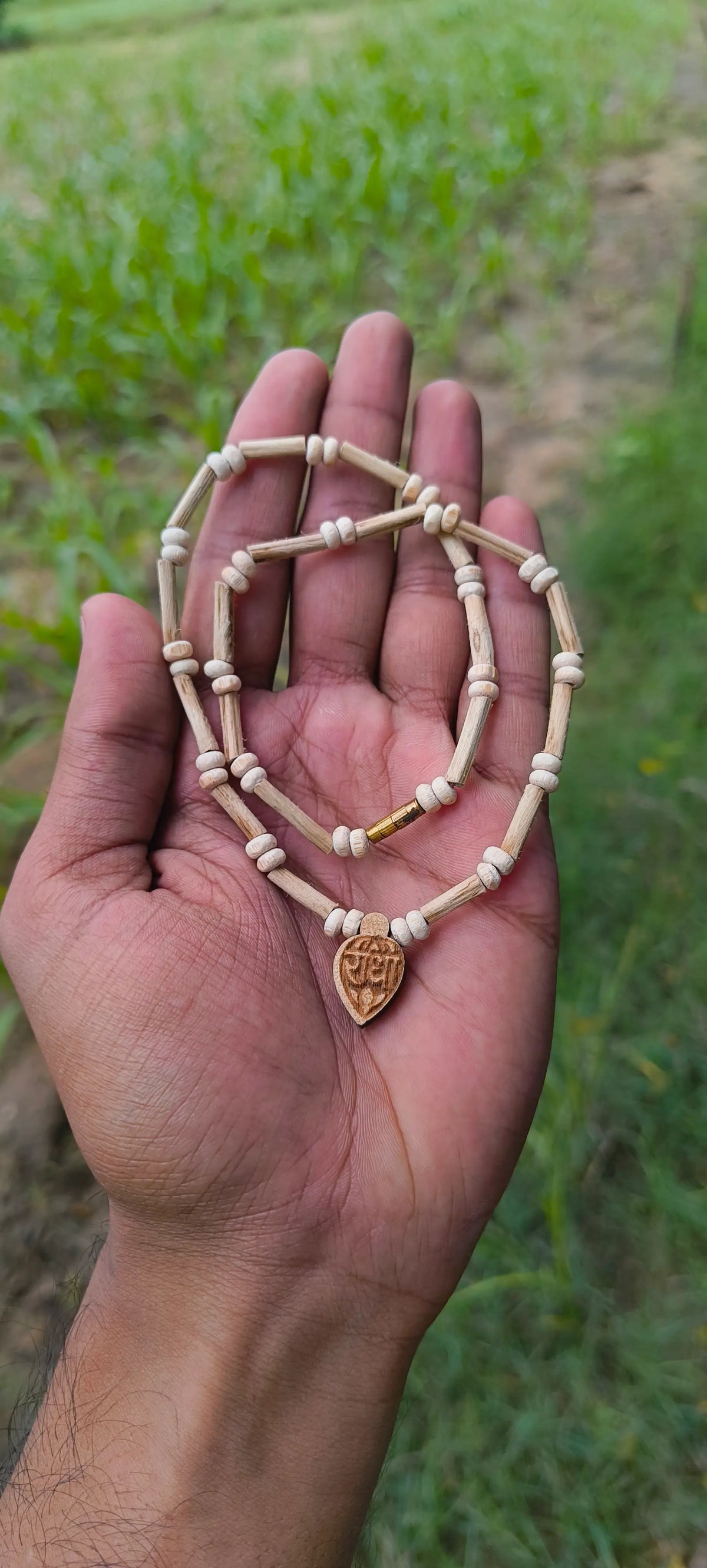 Pure Tulsi kanthi mala with Radha pendant held in hand